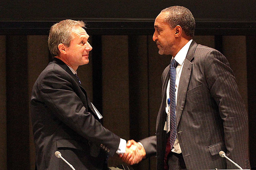 Permanent Representative of Hungary, Csaba Kőrösi, and Permanent Representative of Kenya, Macharia Kamau, Co-Chairs of the Open Working Group, shake hands at the sixth session in December 2013. Photo IISD